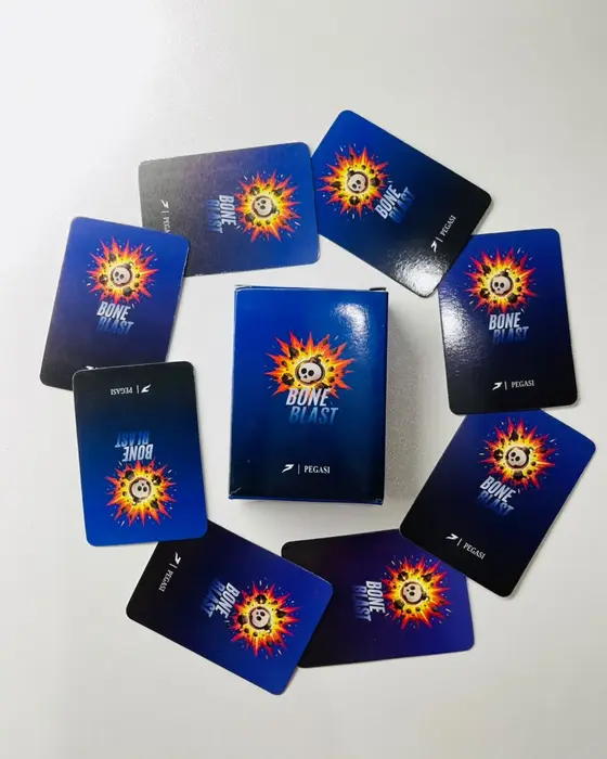 The Bone Blast box standing in the middle of a ring of card backs
