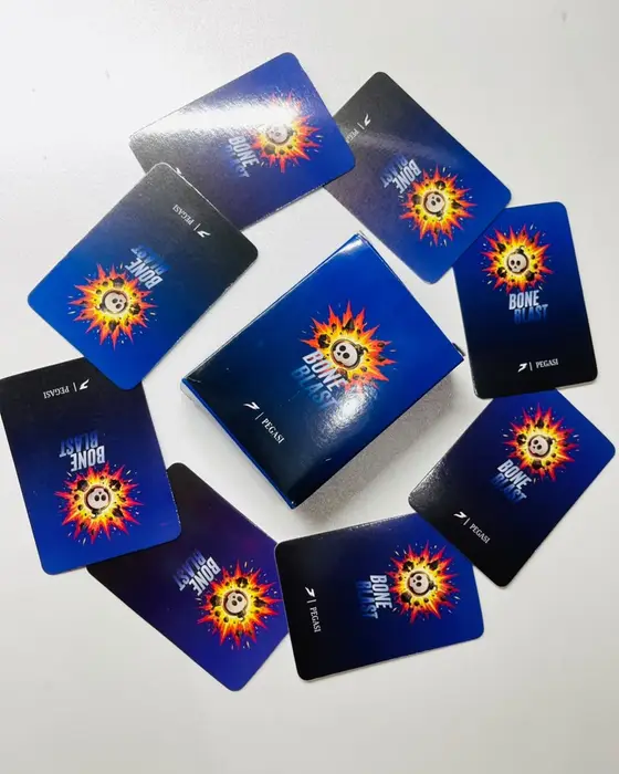 The Bone Blast box lying in the middle of a ring of card backs